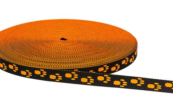 Bild von 25m Rolle Pfötchengurtband - Farbe: Schwarz / Neonorange - 15mm breit